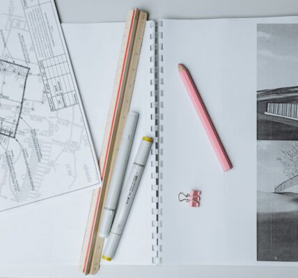 architectural sketches and drafting tools on a desk