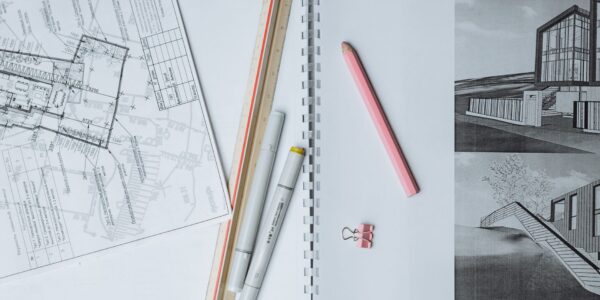 architectural sketches and drafting tools on a desk