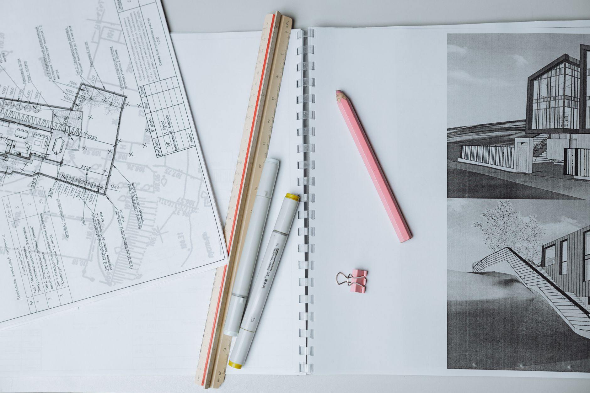 architectural sketches and drafting tools on a desk